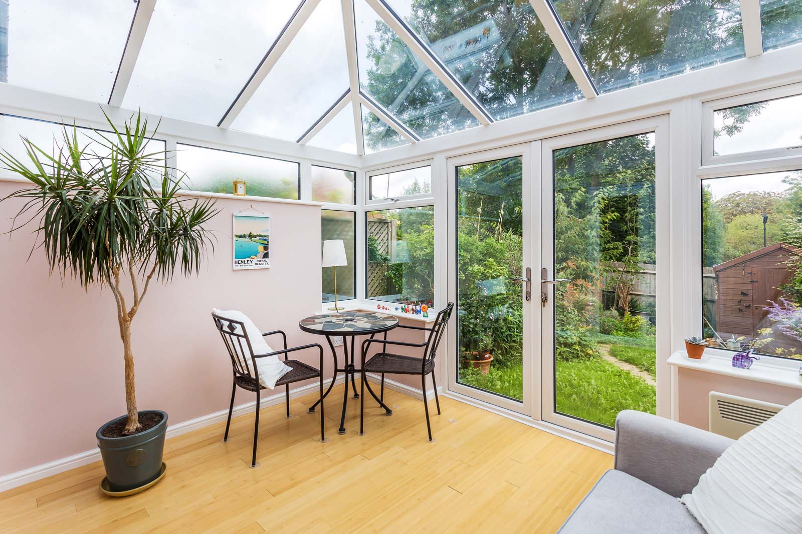 White conservatory with uPVC French doors.