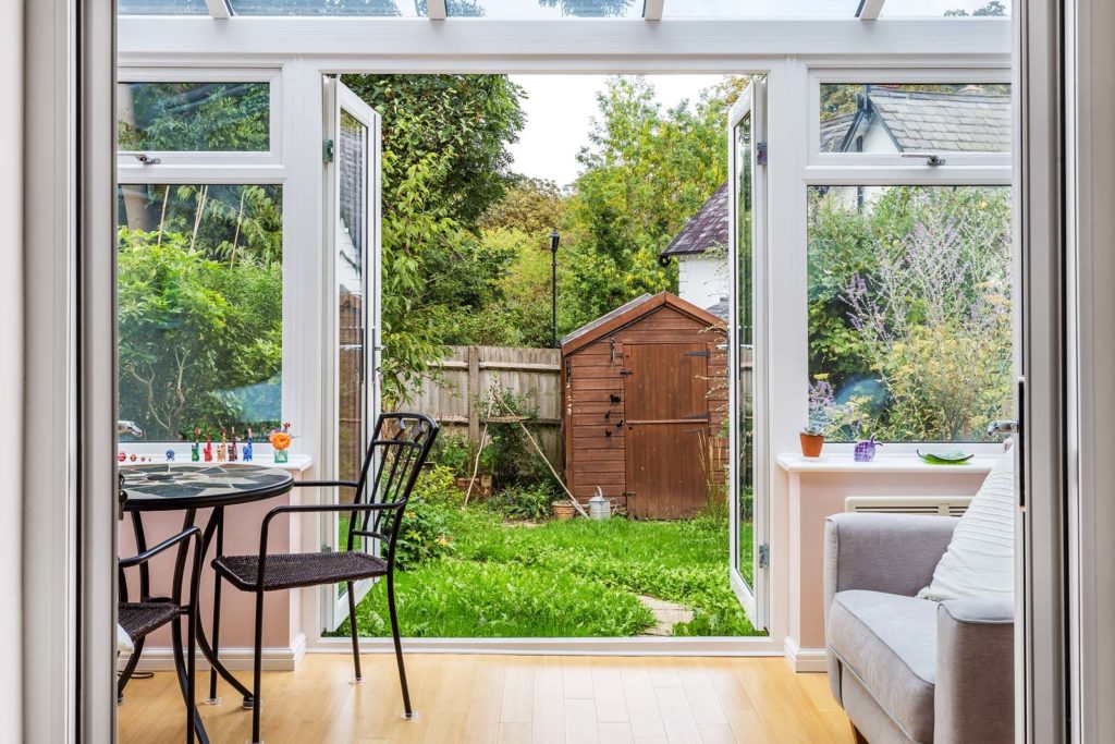 Open white French doors for a home in Sutton.