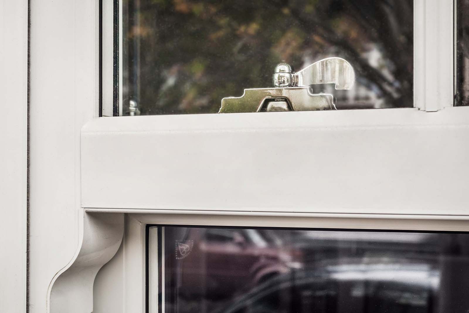 A close up shot of a white sliding sash window frame.