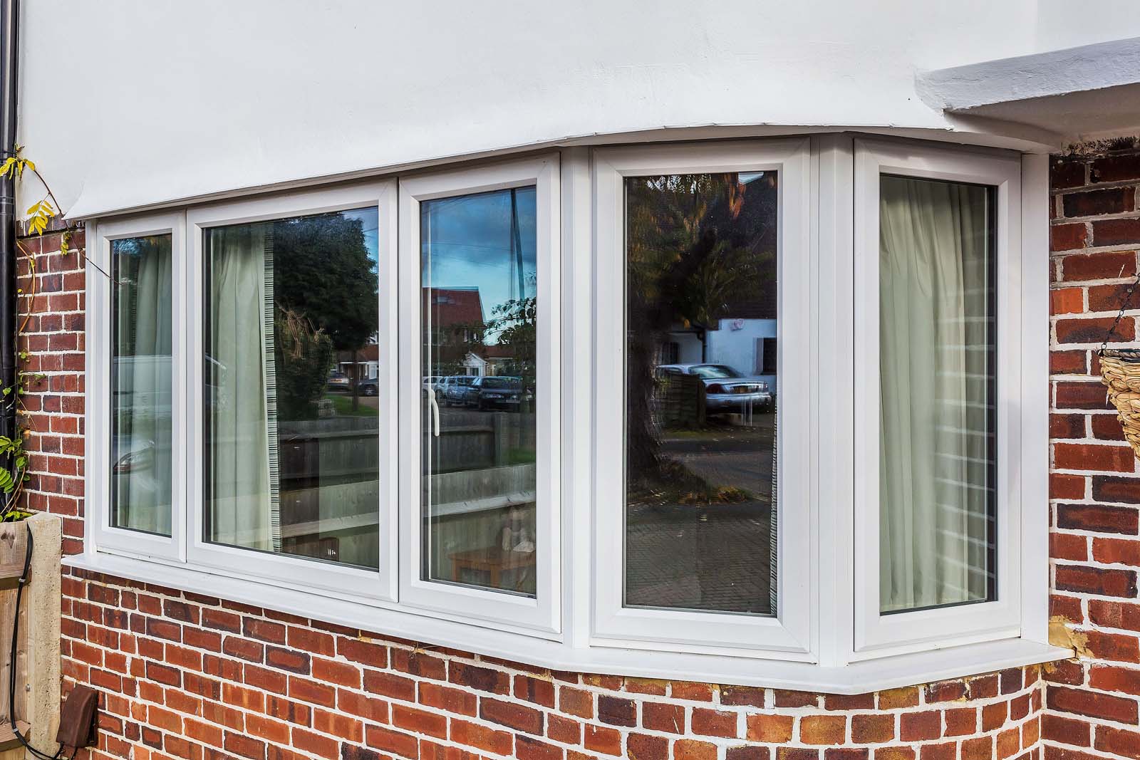 White uPVC bow and bay windows in a Surrey home.