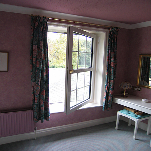 An opened tilt and turn window for a Surrey home.
