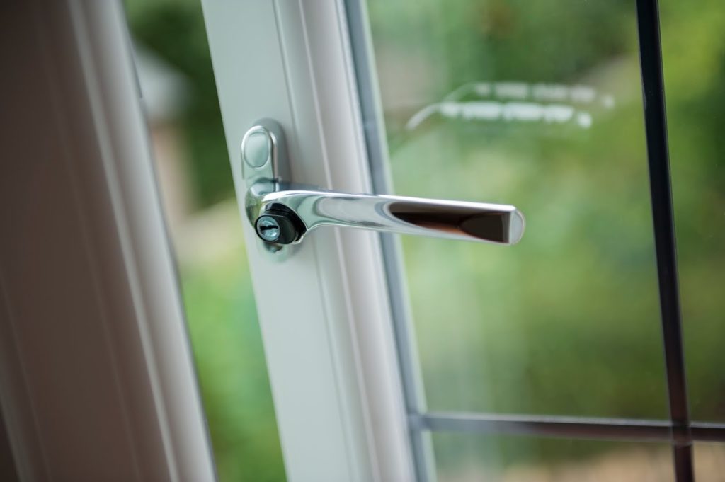 A white casement window handle.